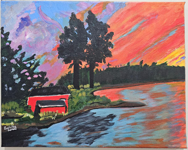 A red cabin sits on a lake as the sun is going down reflecting in the lake.